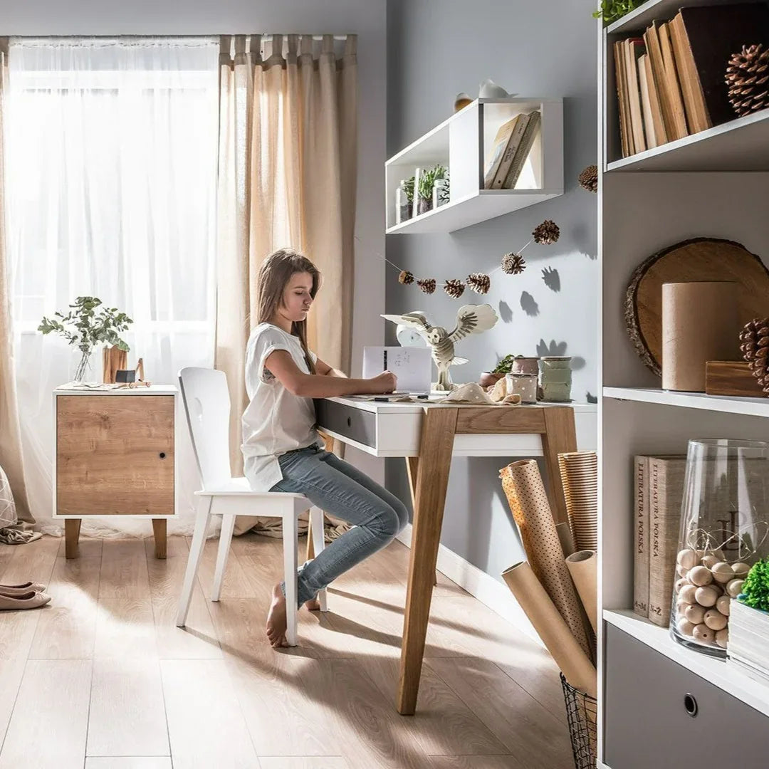 Modern white Concept desk with solid ash wood legs and two drawers for a teen study room in Abu Dhabi.